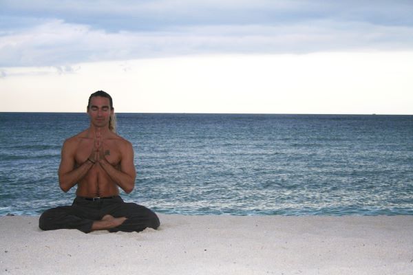 Photo of Tao Semko meditating by the water